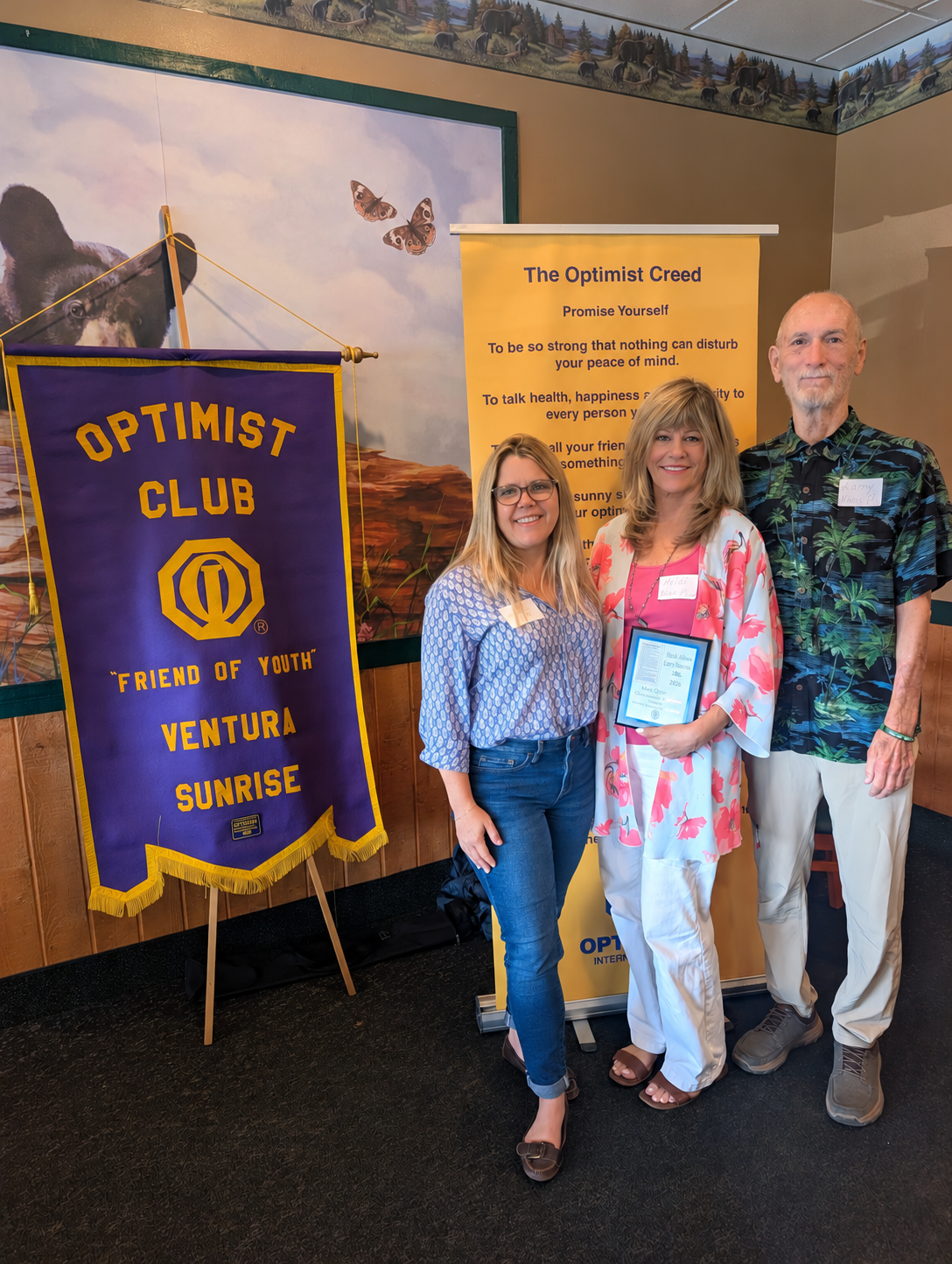Larry Rhoades and Heidi Allison receiving Optimist Award